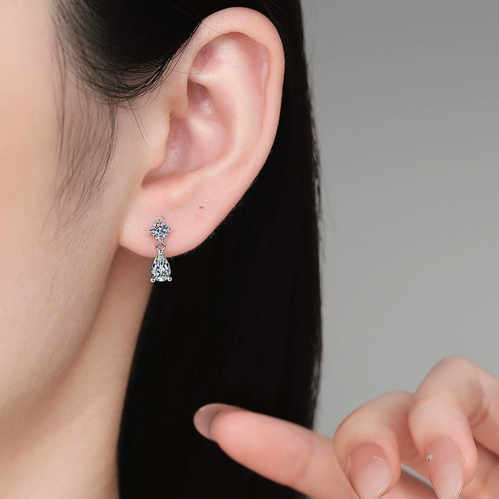 Pear Moissanite Drop Earrings in White Gold-Plated S925 Sterling Silver worn on ear by model