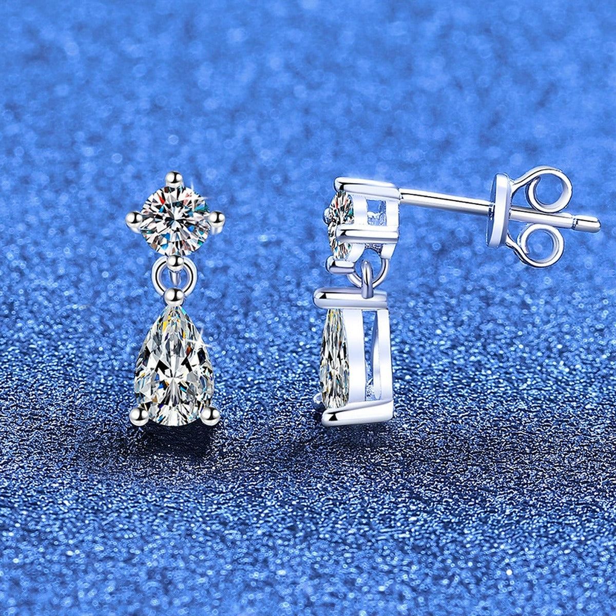 Pear Moissanite Drop Earrings in White Gold-Plated S925 Sterling Silver blue scene angled view