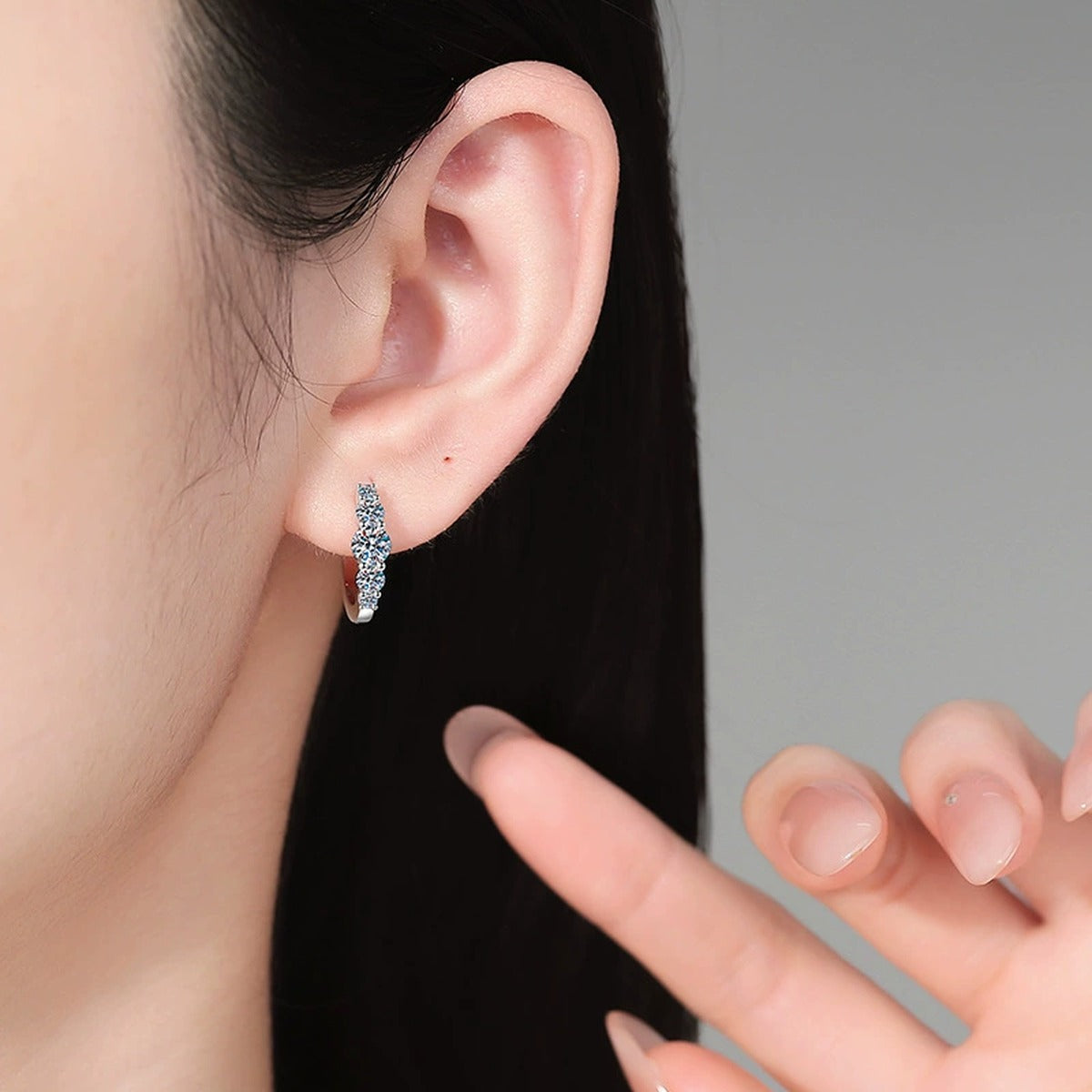 Graduated Moissanite Hoop Earrings in White Gold-Plated S925 Silver worn on ear by model