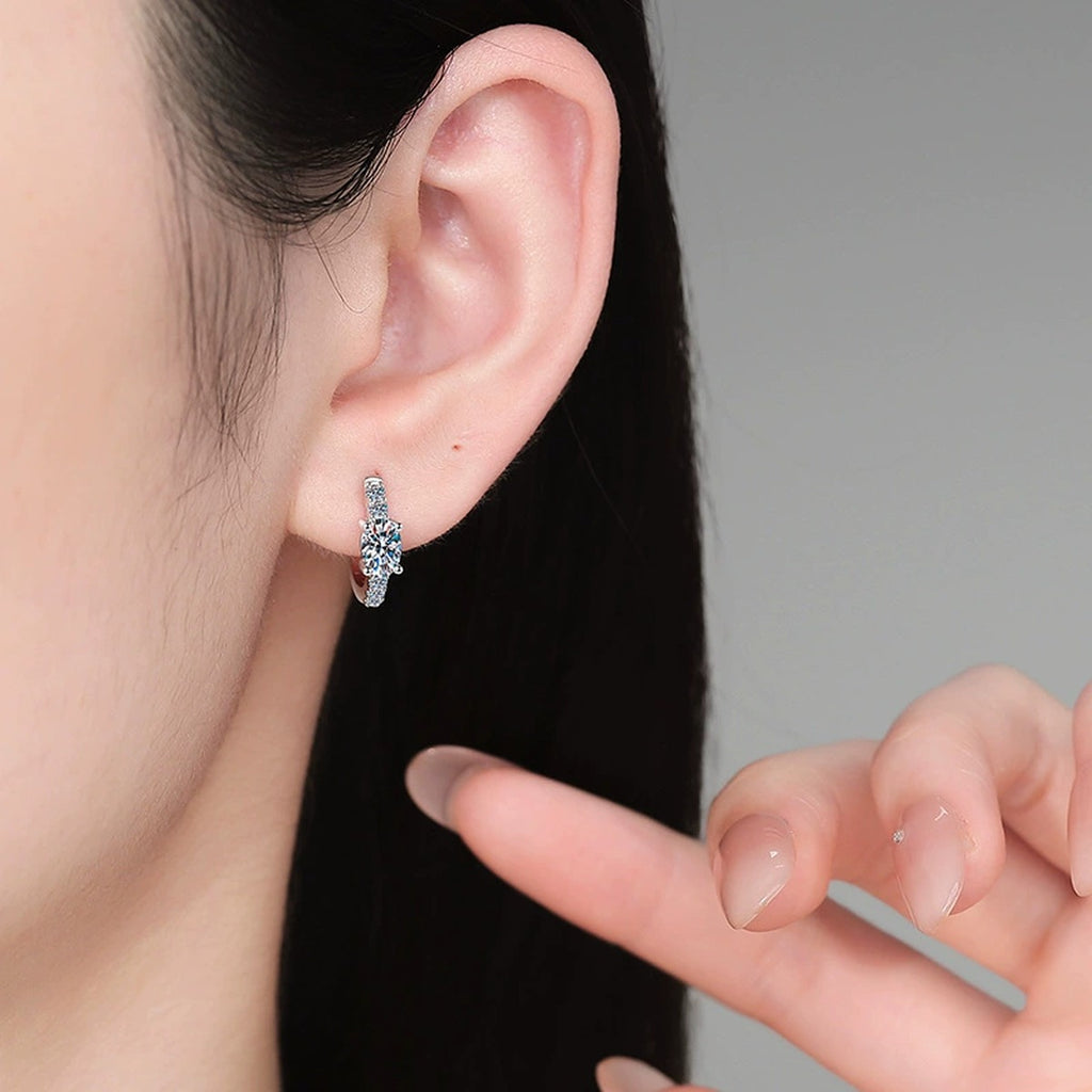 Round Moissanite Huggie Hoop Earrings with CZ in White Gold-Plated S925 Sterling Silver worn on ear by model