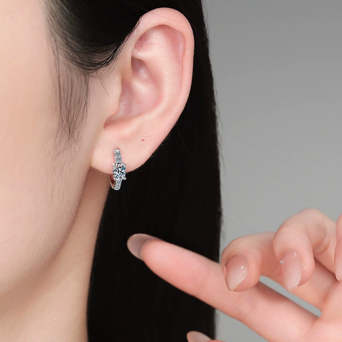 Round Moissanite Huggie Hoop Earrings with CZ in White Gold-Plated S925 Sterling Silver worn on ear by model