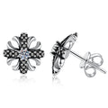 Cross Flower Moissanite Stud Earrings with CZ in White Gold-Plated S925 Sterling Silver on clean white background showing a cross-flower stud with a small round moissanite center and dark CZ accents