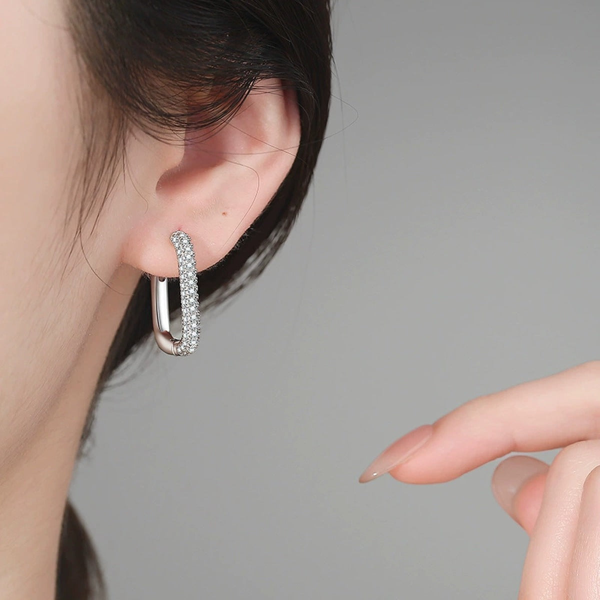 Elongated Pave Moissanite Hoop Earrings in White Gold-Plated S925 Sterling Silver worn on ear by model