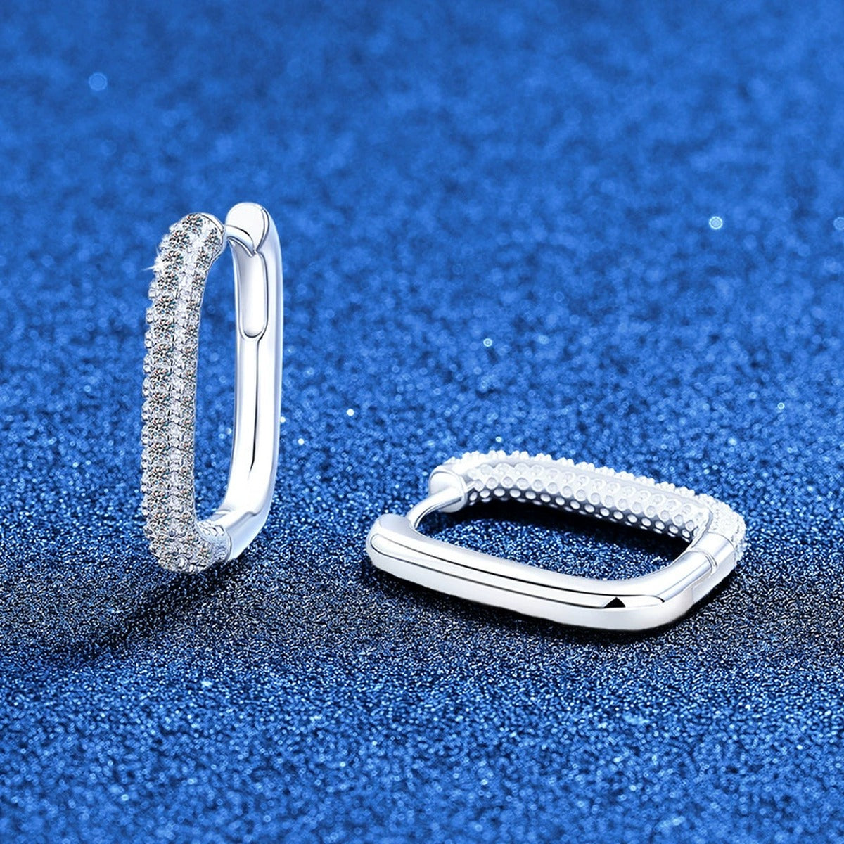 Elongated Pave Moissanite Hoop Earrings in White Gold-Plated S925 Sterling Silver blue scene angled view