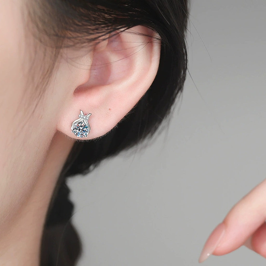 Pear-Shaped Bow Moissanite Stud Earrings in White Gold-Plated S925 Sterling Silver with CZ worn on ear by model