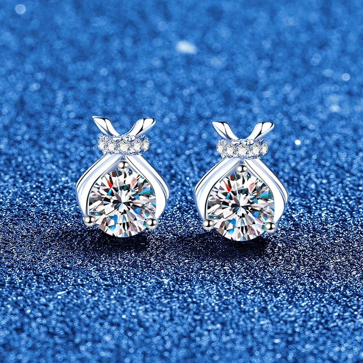 Pear-Shaped Bow Moissanite Stud Earrings in White Gold-Plated S925 Sterling Silver with CZ blue scene angled view
