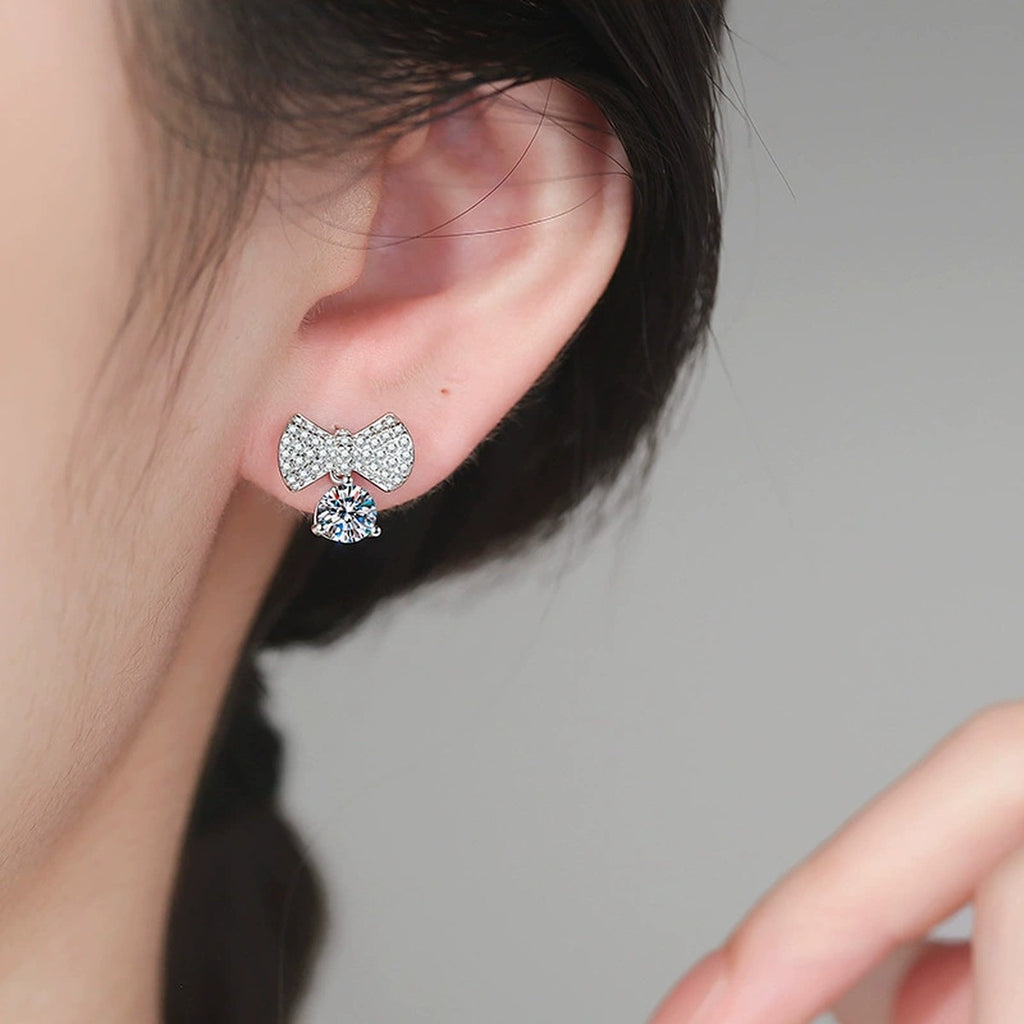 Bow Drop Moissanite Stud Earrings in White Gold-Plated S925 Sterling Silver with CZ worn on ear by model
