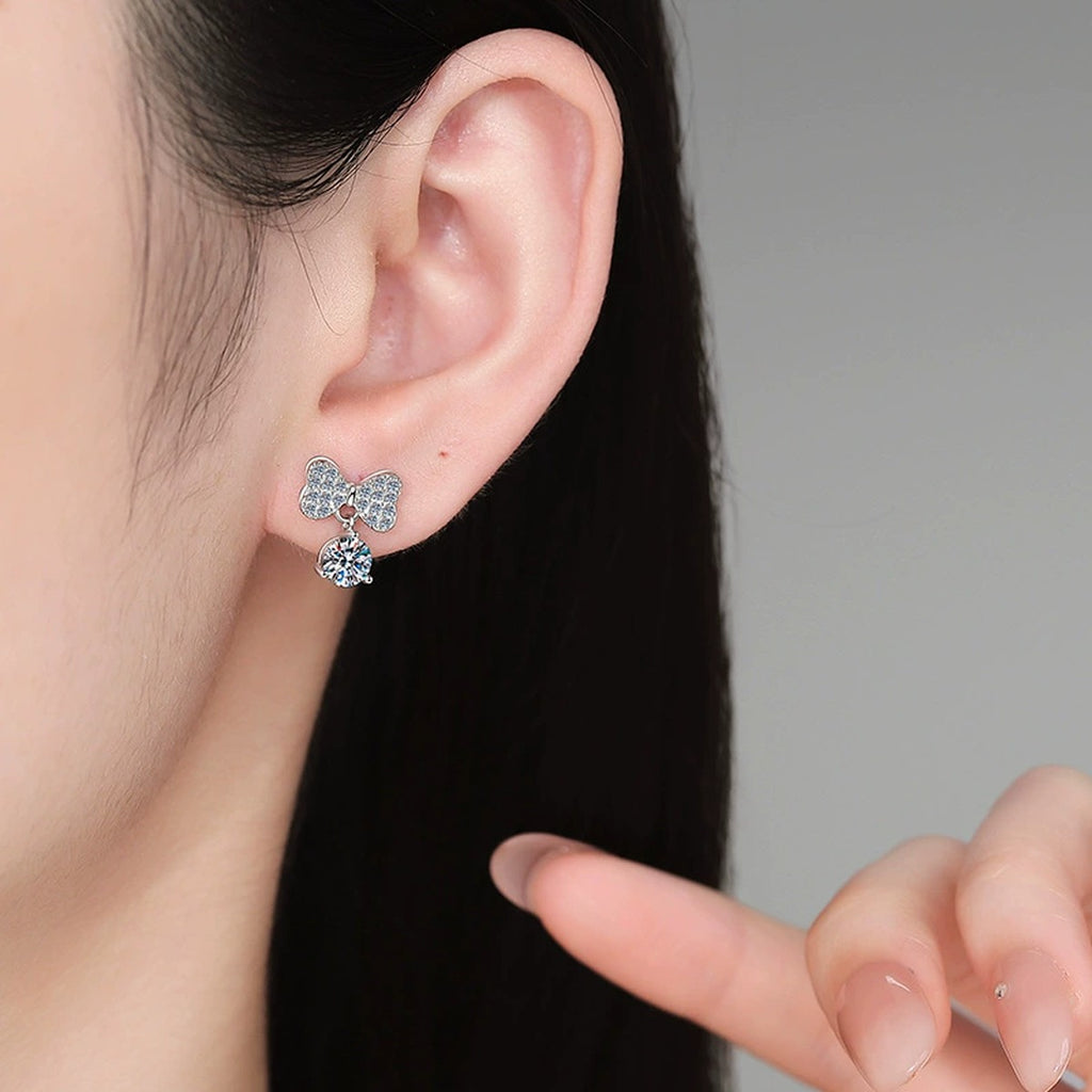 Ribbon Bow Moissanite Drop Earrings in White Gold-Plated S925 Sterling Silver with CZ worn on ear by model
