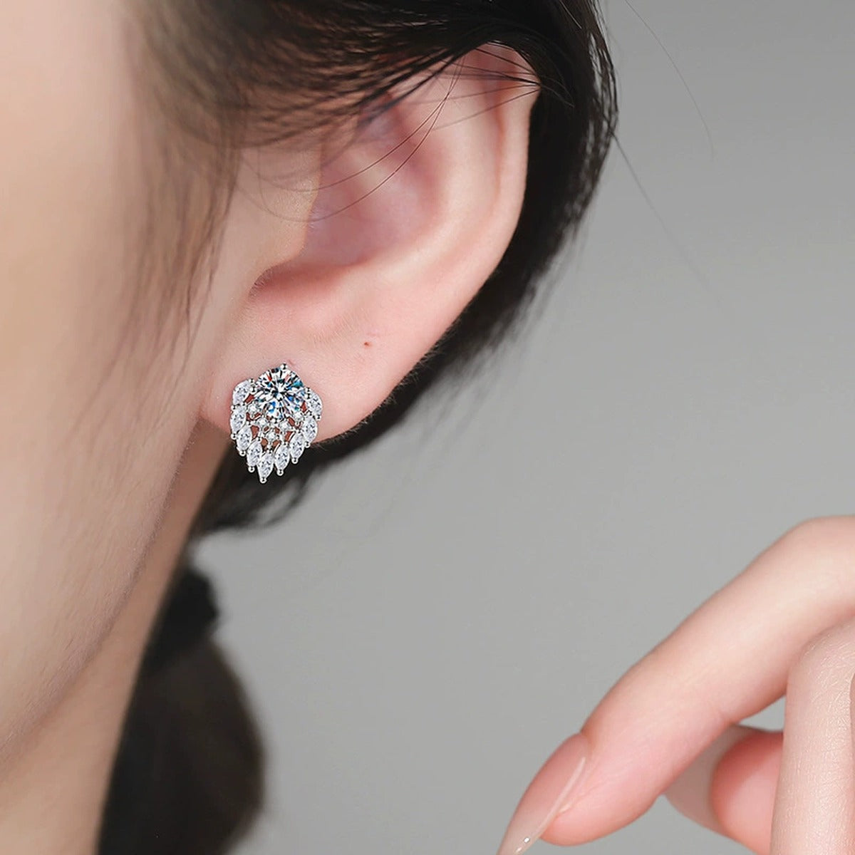 Pear Halo Moissanite Stud Earrings in White Gold-Plated S925 Sterling Silver with CZ worn on ear by model