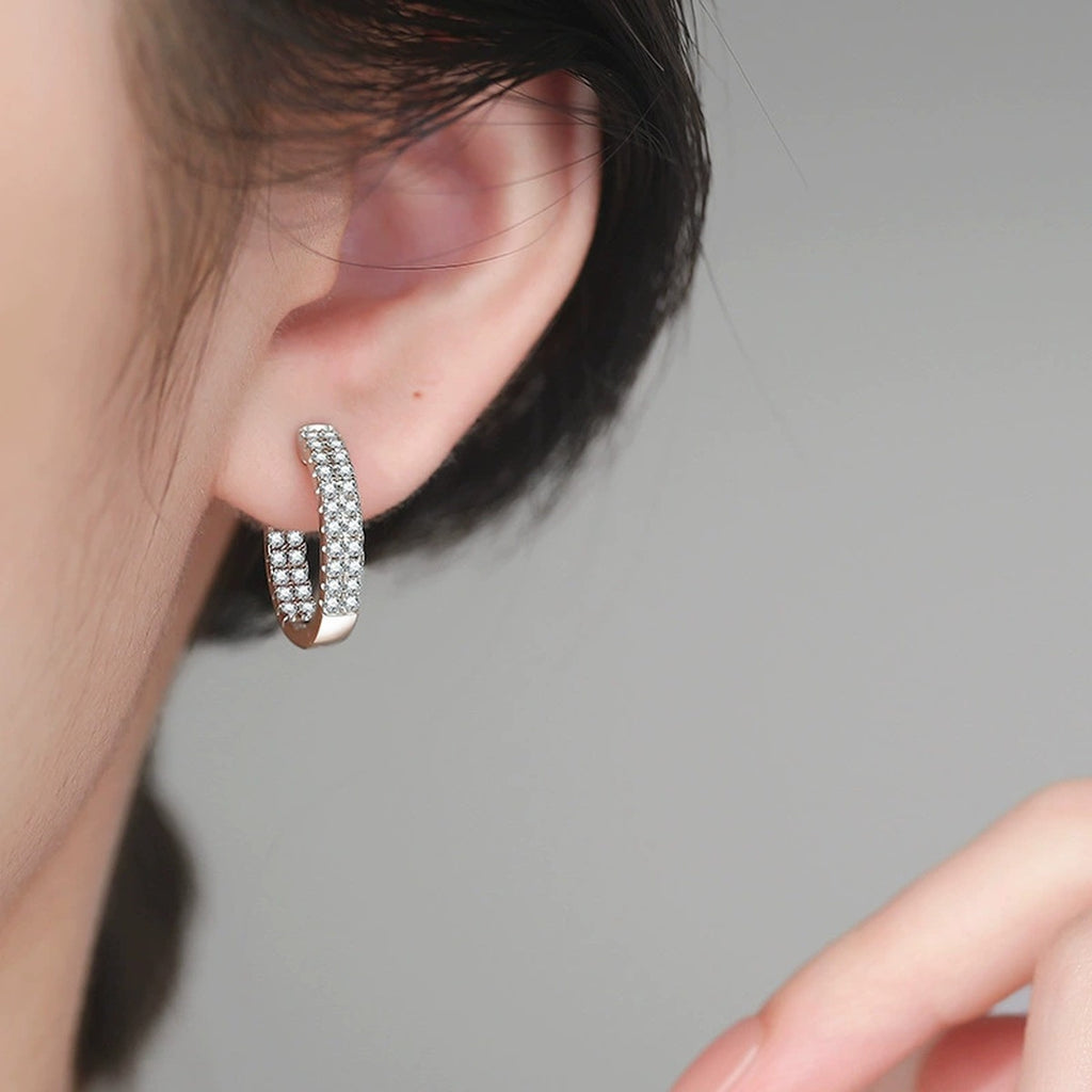 Wide Pave Moissanite Hoop Earrings in White Gold-Plated S925 Sterling Silver worn on ear by model