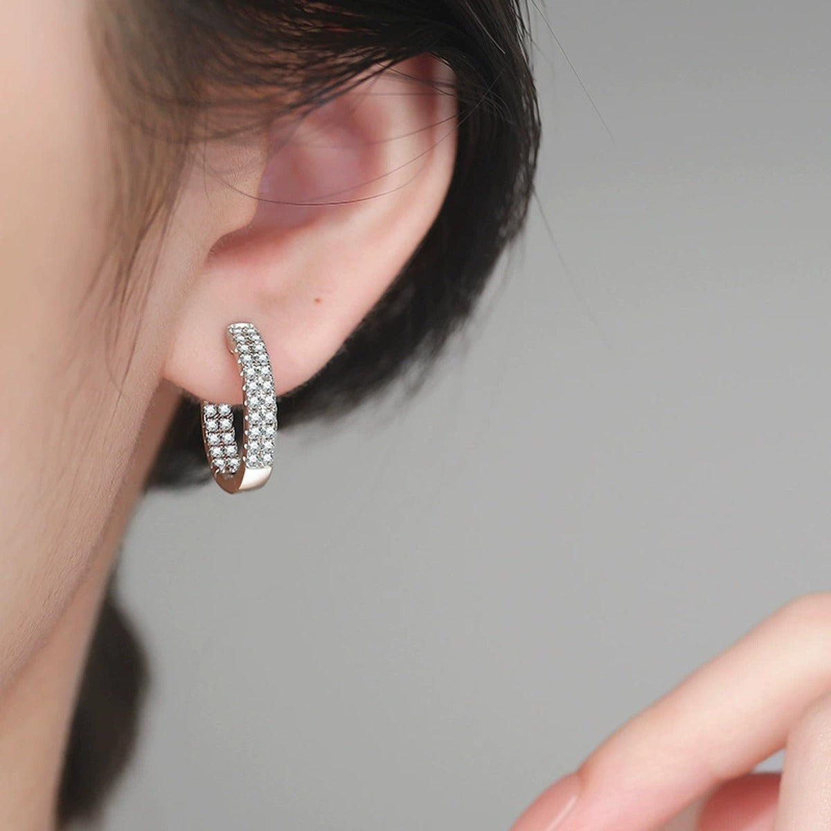 Wide Pave Moissanite Hoop Earrings in White Gold-Plated S925 Sterling Silver worn on ear by model