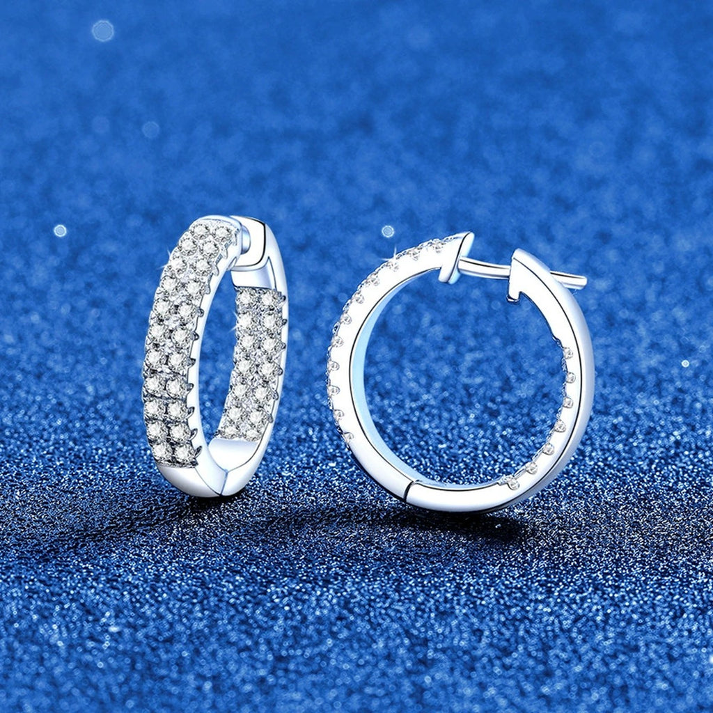 Wide Pave Moissanite Hoop Earrings in White Gold-Plated S925 Sterling Silver blue scene angled view