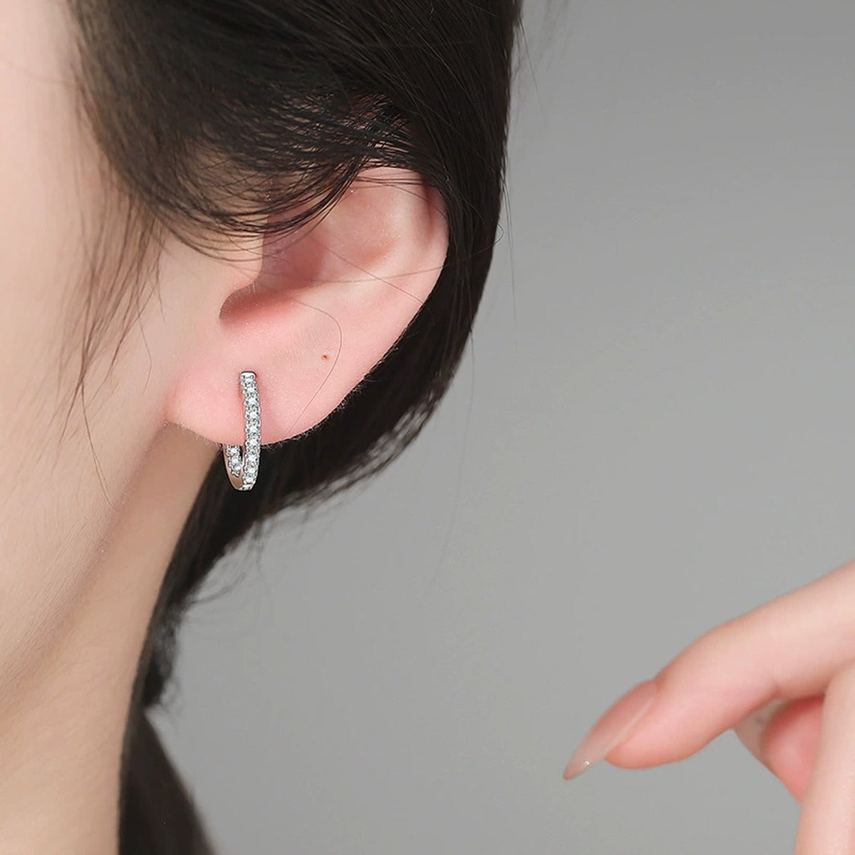 Slim Pave Moissanite Hoop Earrings in White Gold-Plated S925 Sterling Silver worn on ear by model