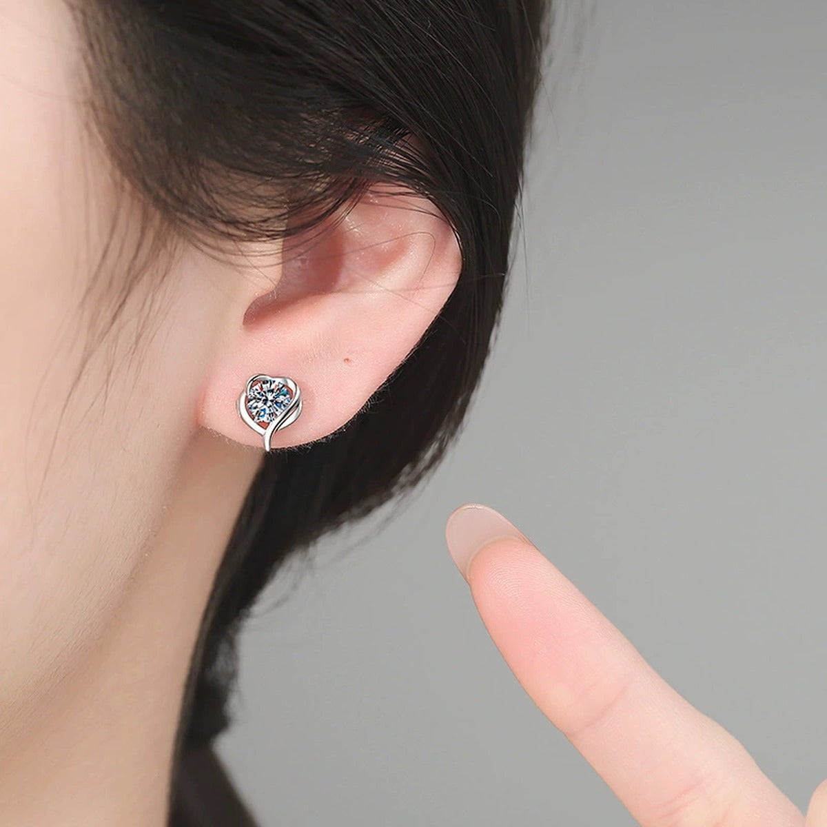 Swirl Heart Moissanite Stud Earrings in White Gold-Plated S925 Sterling Silver worn on ear by model