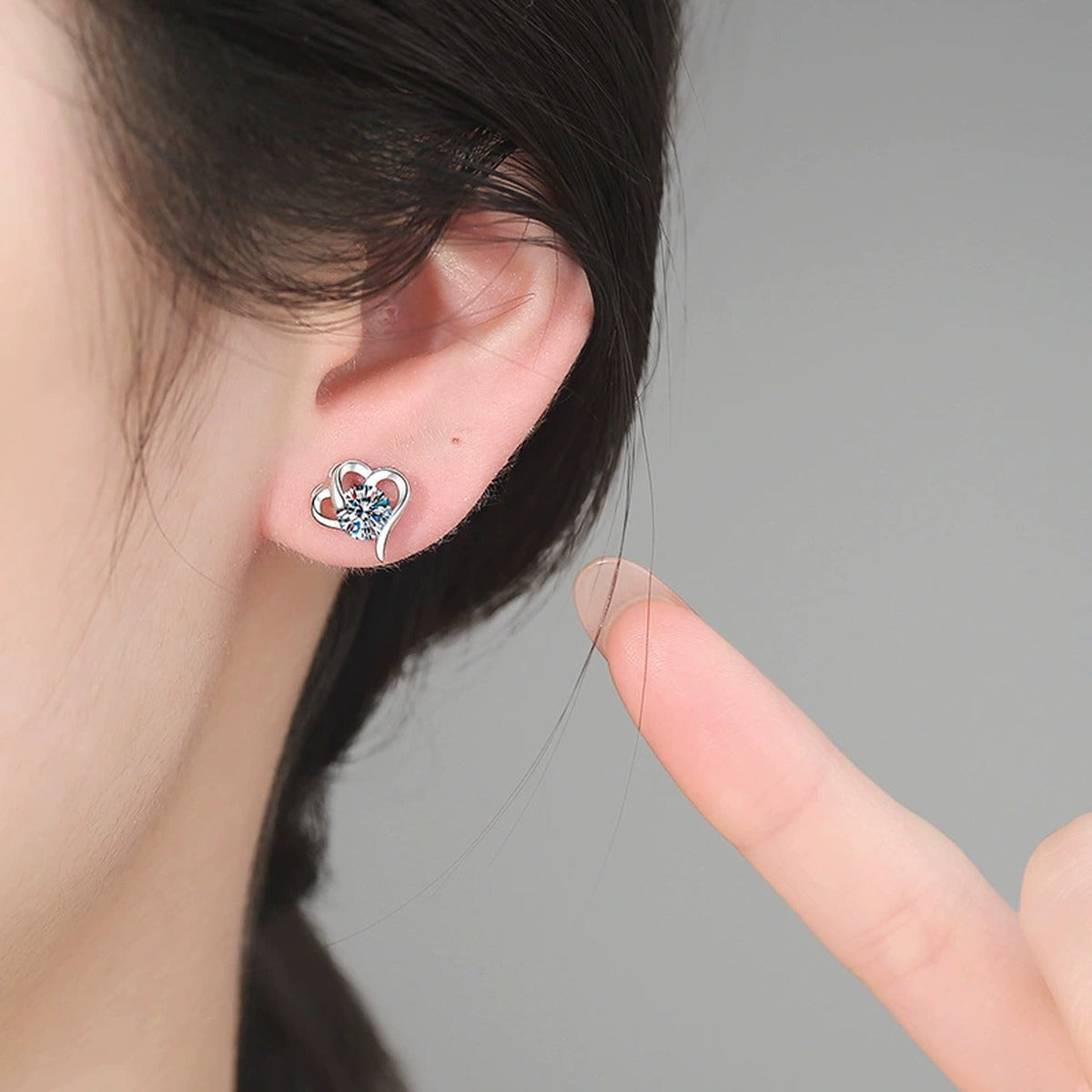 Open Heart Moissanite Stud Earrings in White Gold-Plated S925 Sterling Silver worn on ear by model