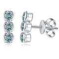 Green Moissanite Three-Stone Stud Earrings in White Gold-Plated S925 Sterling Silver on clean white background showing a vertical three-stone green moissanite stud silhouette
