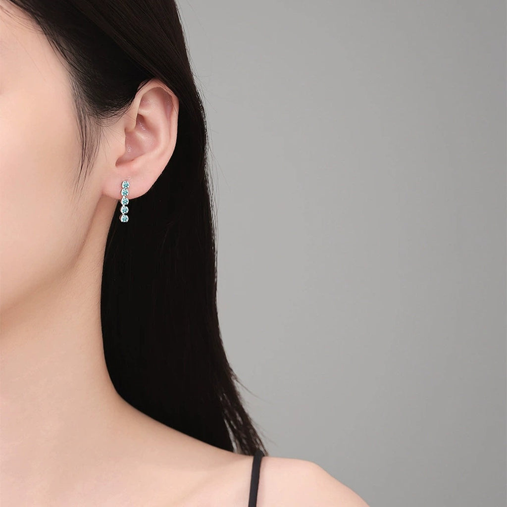 Green Moissanite Line Stud Earrings in White Gold-Plated S925 Silver worn on ear by model