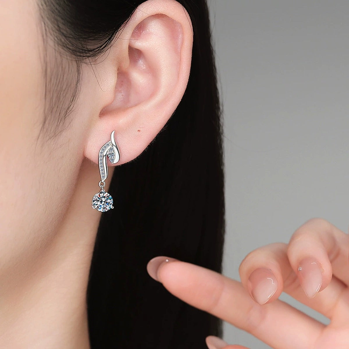 Swirl Moissanite Drop Earrings with CZ in White Gold-Plated S925 Silver worn on ear by model