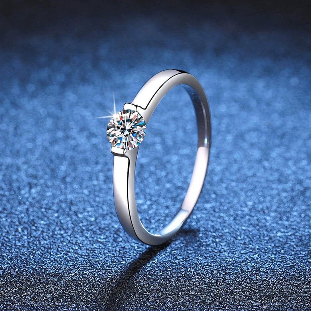 Round Solitaire Moissanite Engagement Ring blue background product view