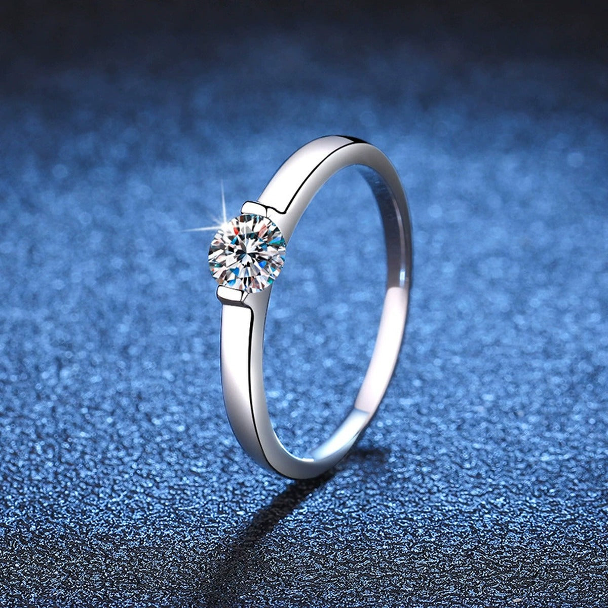 Round Solitaire Moissanite Engagement Ring blue background product view