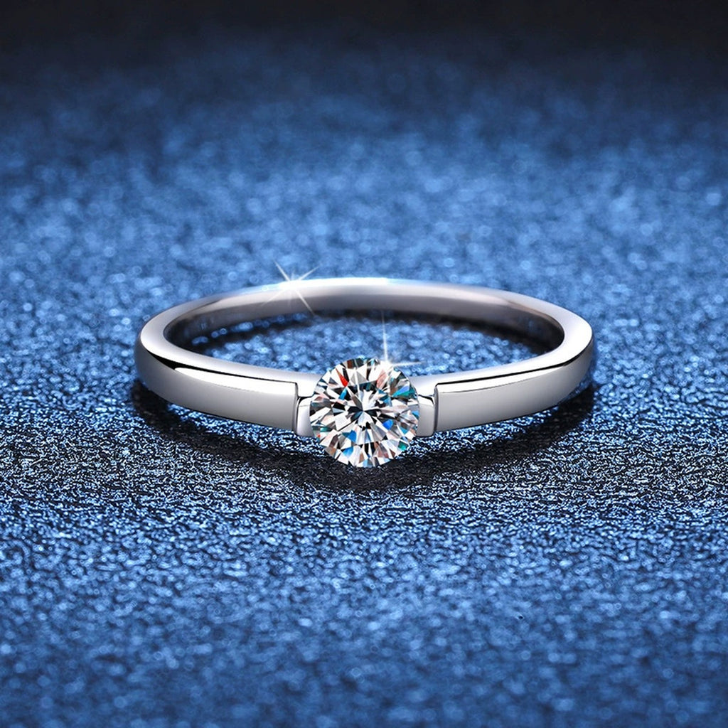 Round Solitaire Moissanite Engagement Ring blue background product view