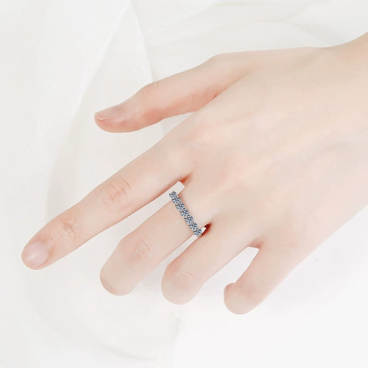 Graduated Moissanite Half Eternity Ring worn on hand by model