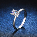 Emerald Cut Moissanite Solitaire Ring blue background product view