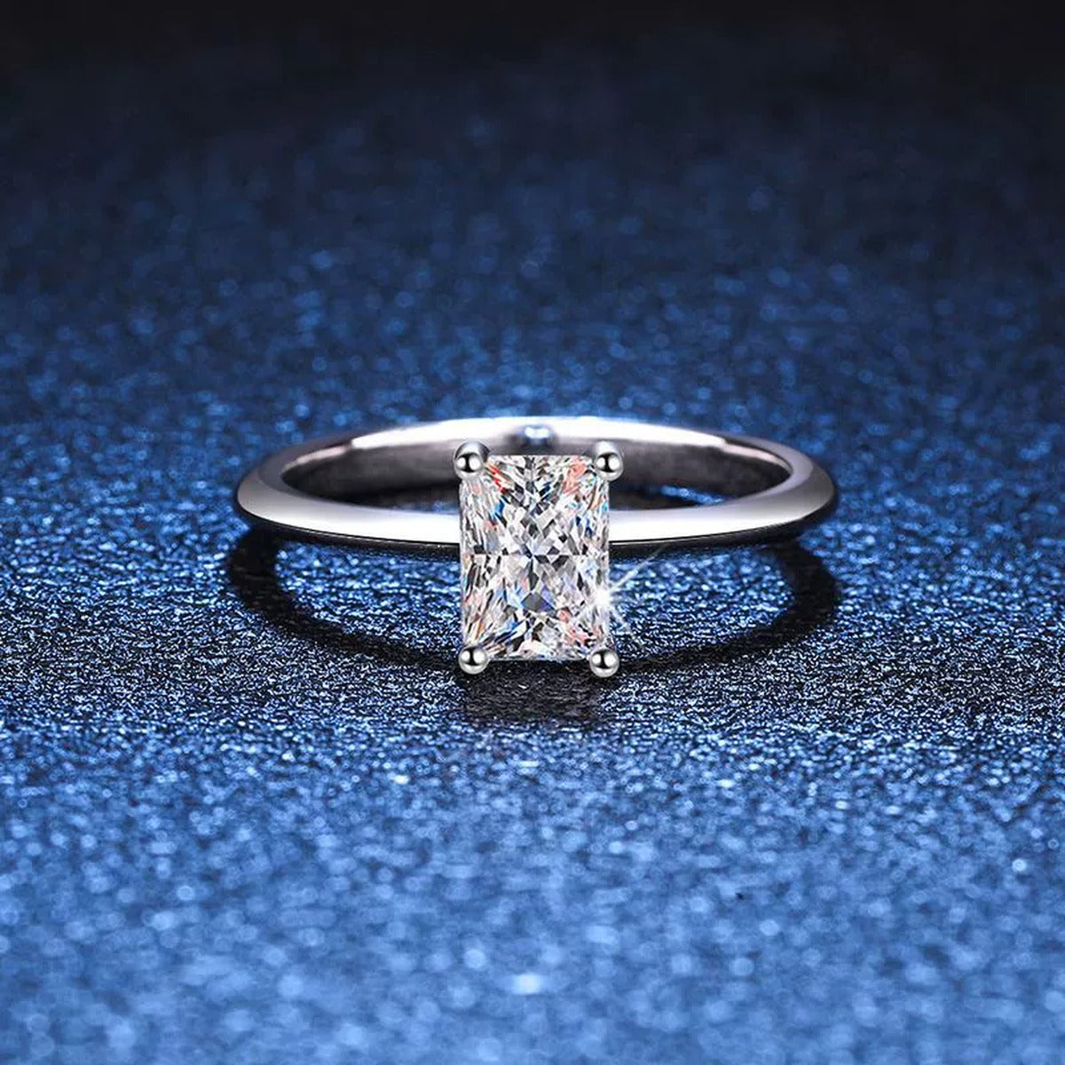 Emerald Cut Moissanite Solitaire Ring blue background product view