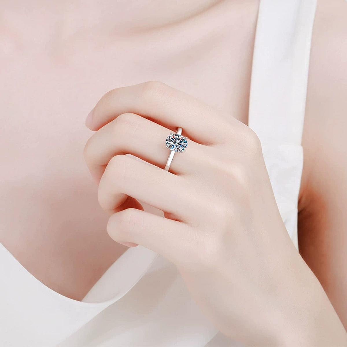 Oval Moissanite Engagement Ring with CZ worn on hand by model