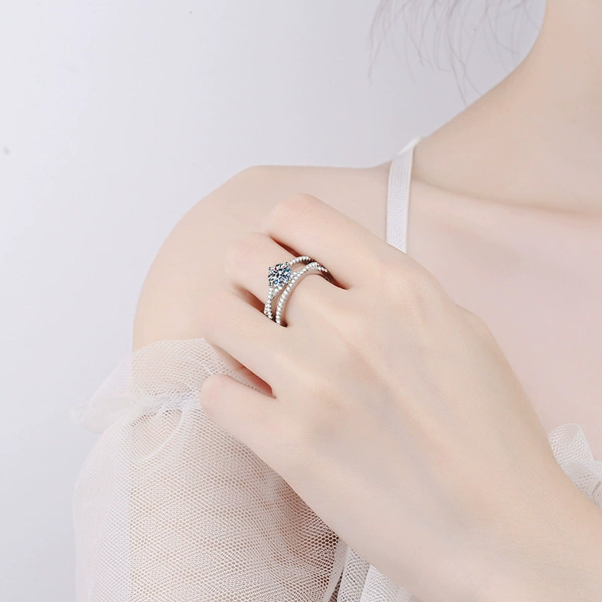 Split Shank Round Moissanite Ring with CZ worn on hand by model
