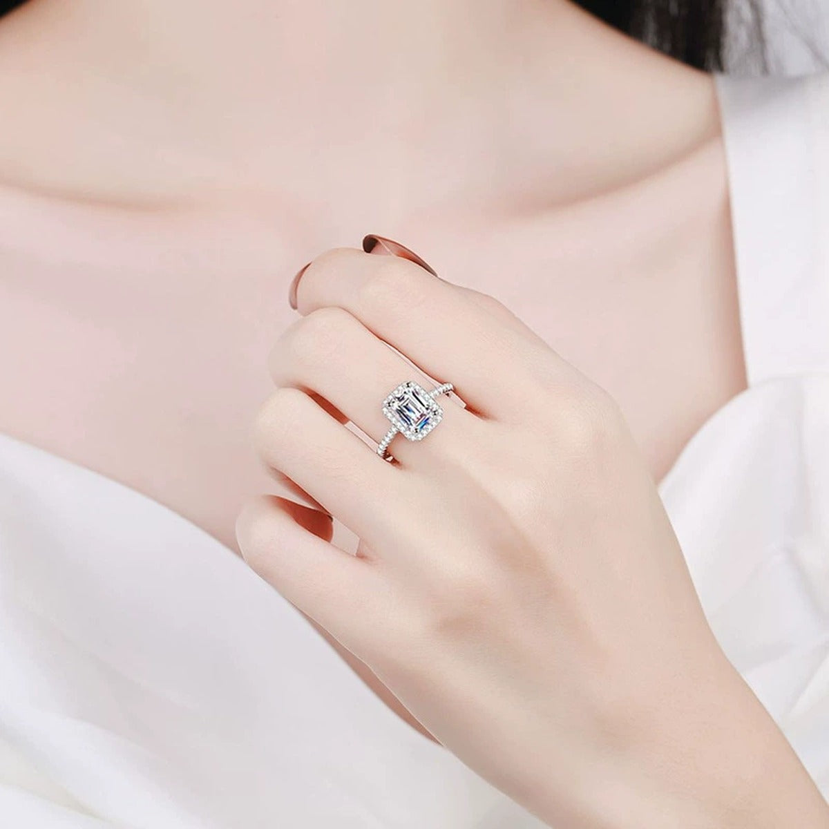 Emerald and Radiant Cut Moissanite Ring with CZ worn on hand by model