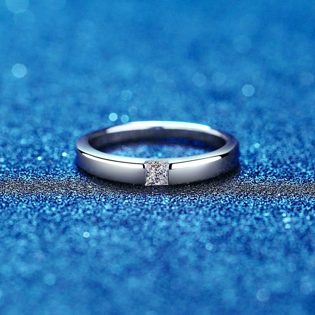 Bezel Moissanite Band Ring with CZ blue background product view
