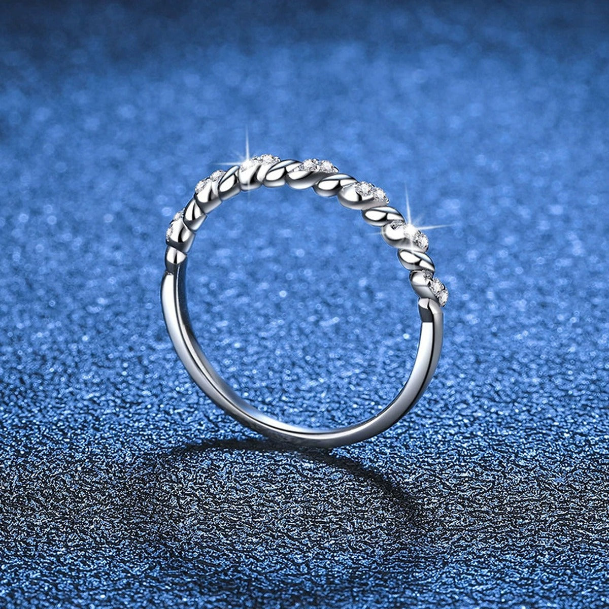 Twisted Moissanite Band Ring blue background product view