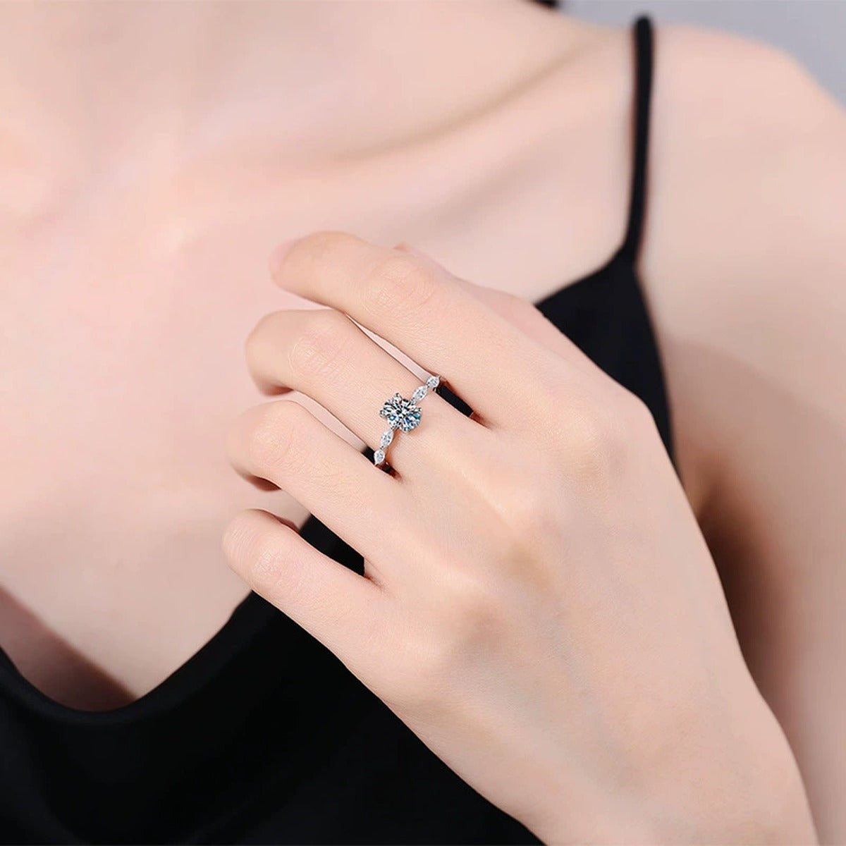 Pear Shaped Moissanite Ring with CZ worn on hand by model