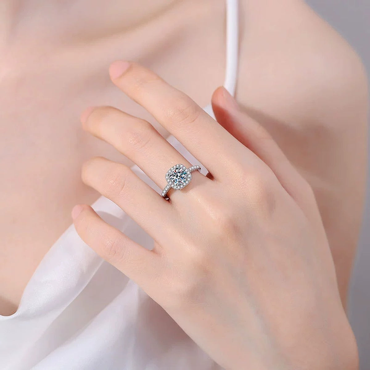 Cushion Halo Moissanite Engagement Ring with CZ worn on hand by model
