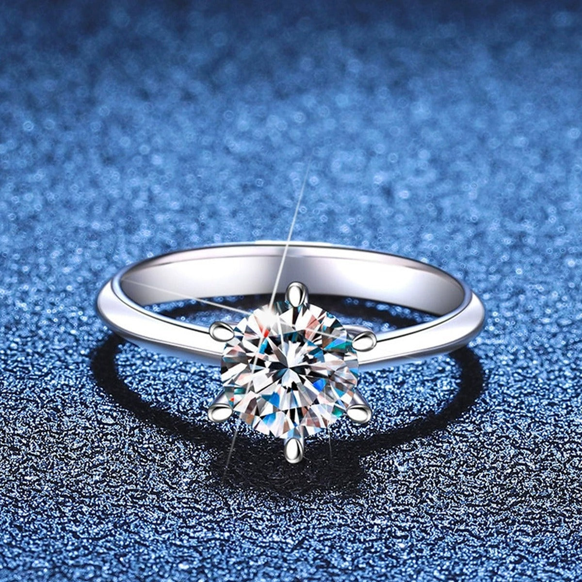 Round Moissanite Solitaire Ring blue background product view
