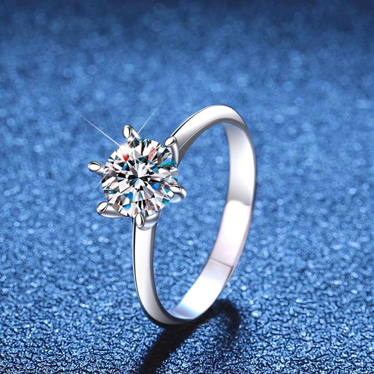 Round Moissanite Solitaire Ring blue background product view