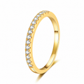 A yellow gold eternity-style ring featuring a single row of round clear gemstones along the outer band, shown on a clean white background with a soft shadow.