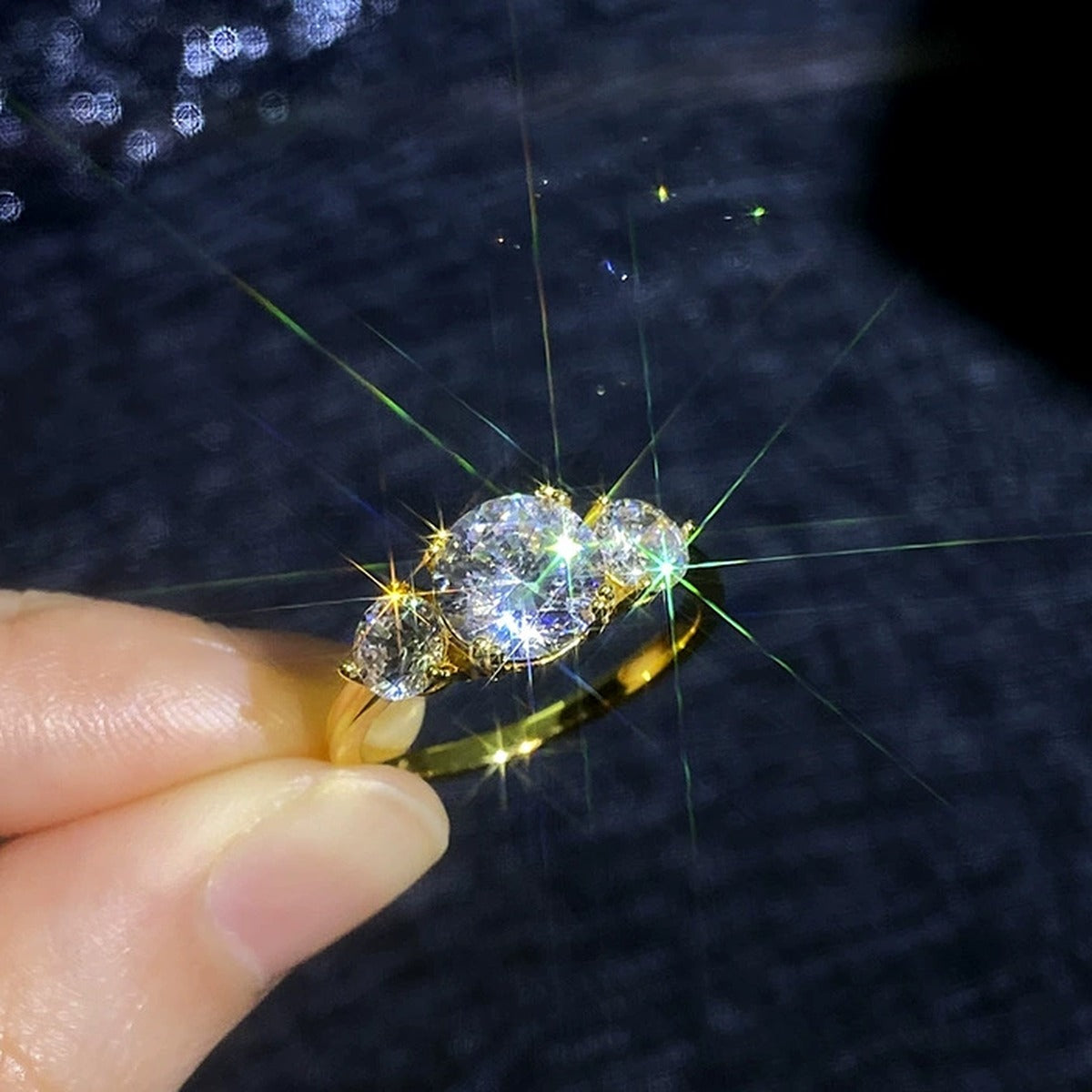 Three Stone Moissanite Ring in Yellow Gold-Plated S925 Sterling Silver dark background detail view