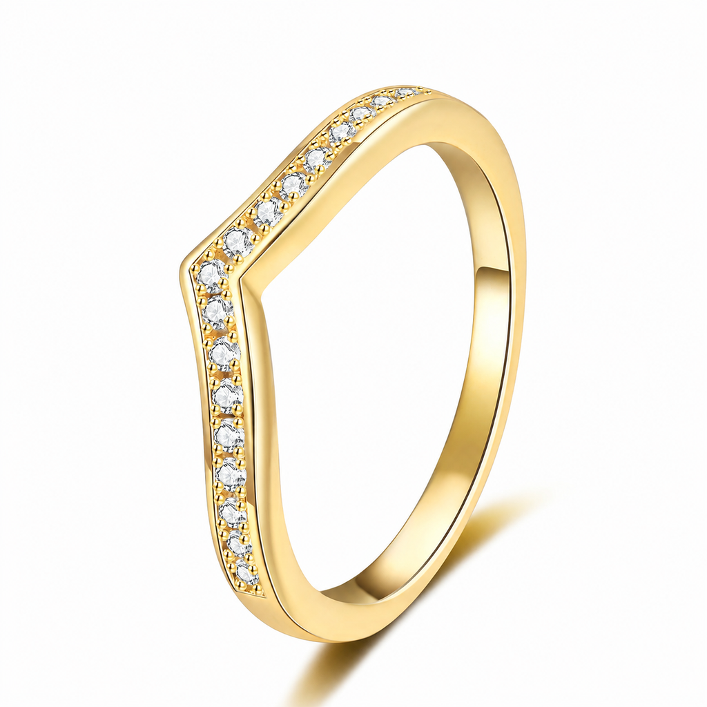 A gold ring with a wavy, shield-like top featuring a channel-set row of clear stones, shown on a clean white background.