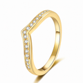 A gold ring with a wavy, shield-like top featuring a channel-set row of clear stones, shown on a clean white background.