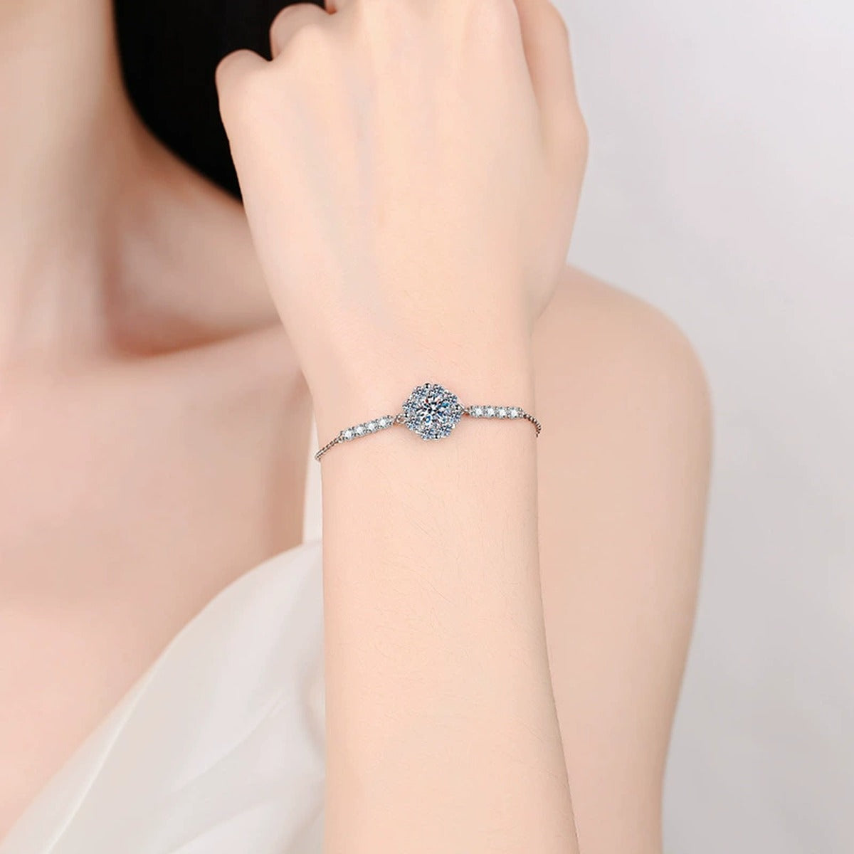 Halo Round Moissanite Adjustable Chain Bracelet with CZ in White Gold-Plated S925 Sterling Silver worn on wrist model view showing scale and fit
