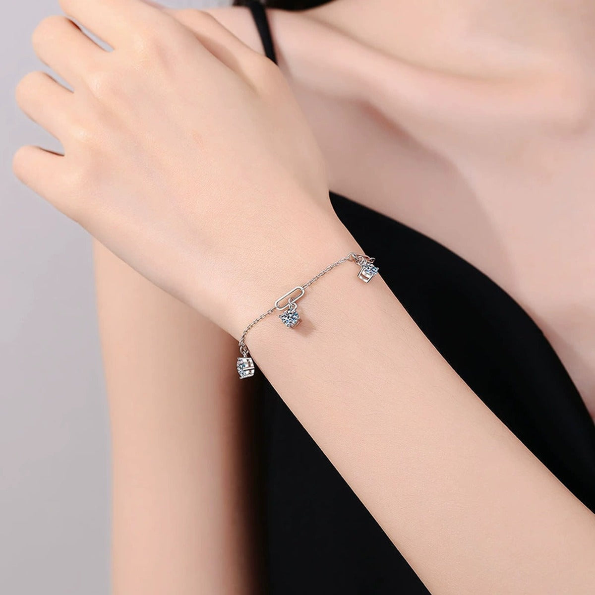 Multi-Charm Moissanite Chain Bracelet in White Gold-Plated S925 Sterling Silver worn on wrist model view showing scale and fit