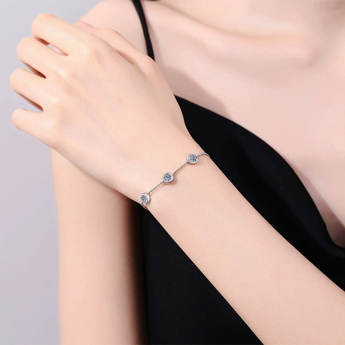 Three-Stone Moissanite Adjustable Chain Bracelet in White Gold-Plated S925 Sterling Silver worn on wrist model view showing scale and fit