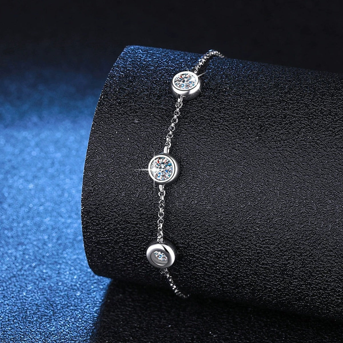 Three-Stone Moissanite Adjustable Chain Bracelet in White Gold-Plated S925 Sterling Silver blue display scene showing bracelet sparkle and chain detail