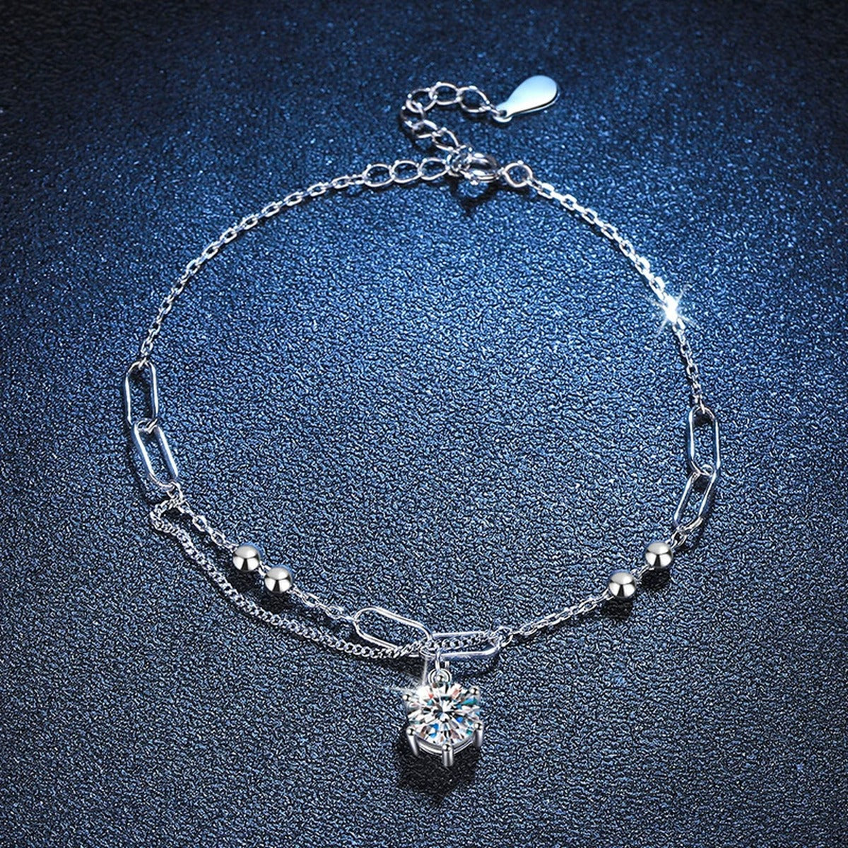 Drop Moissanite Chain Bracelet in White Gold-Plated S925 Sterling Silver blue display scene showing bracelet sparkle and chain detail