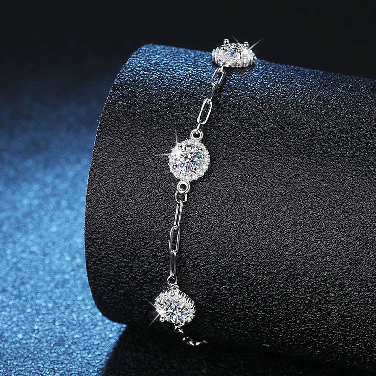 Three-Stone Round Moissanite Chain Bracelet with CZ in White Gold-Plated S925 Sterling Silver blue display scene showing bracelet sparkle and chain detail