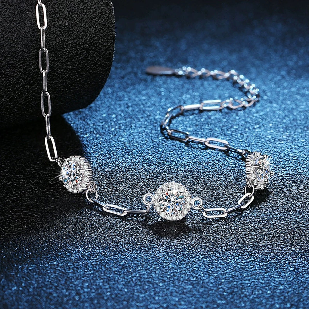 Three-Stone Round Moissanite Chain Bracelet with CZ in White Gold-Plated S925 Sterling Silver blue display scene showing bracelet sparkle and chain detail