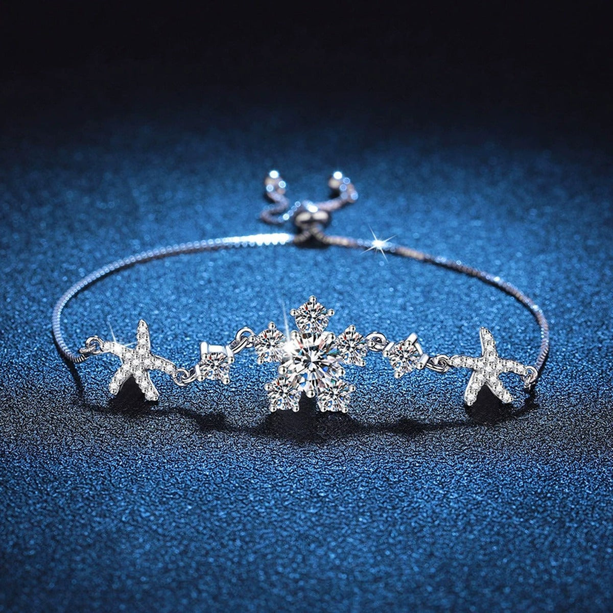 Floral Moissanite Adjustable Bracelet with CZ styled on blue display background showing moissanite sparkle and chain detail