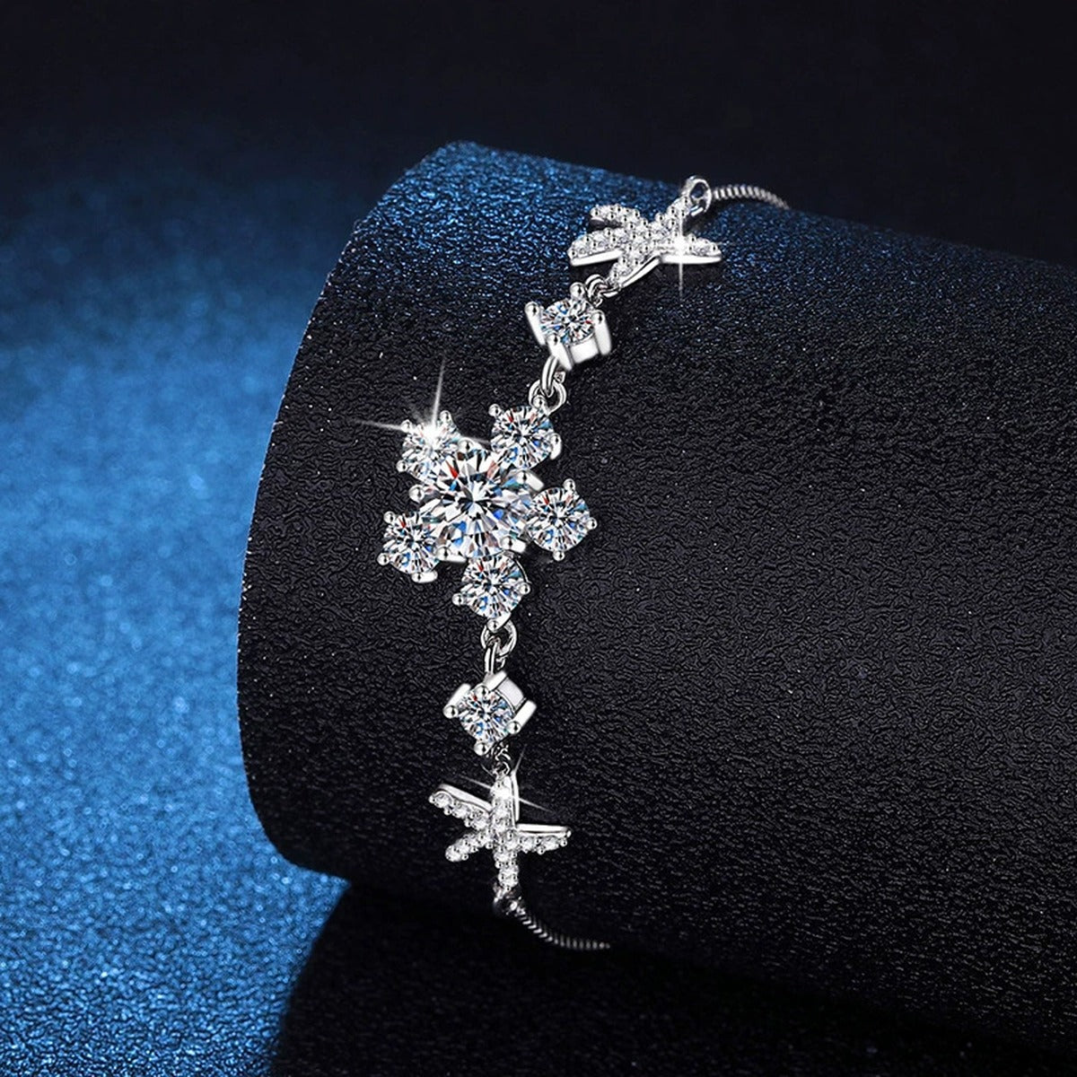 Floral Moissanite Adjustable Bracelet with CZ styled on blue display background showing moissanite sparkle and chain detail